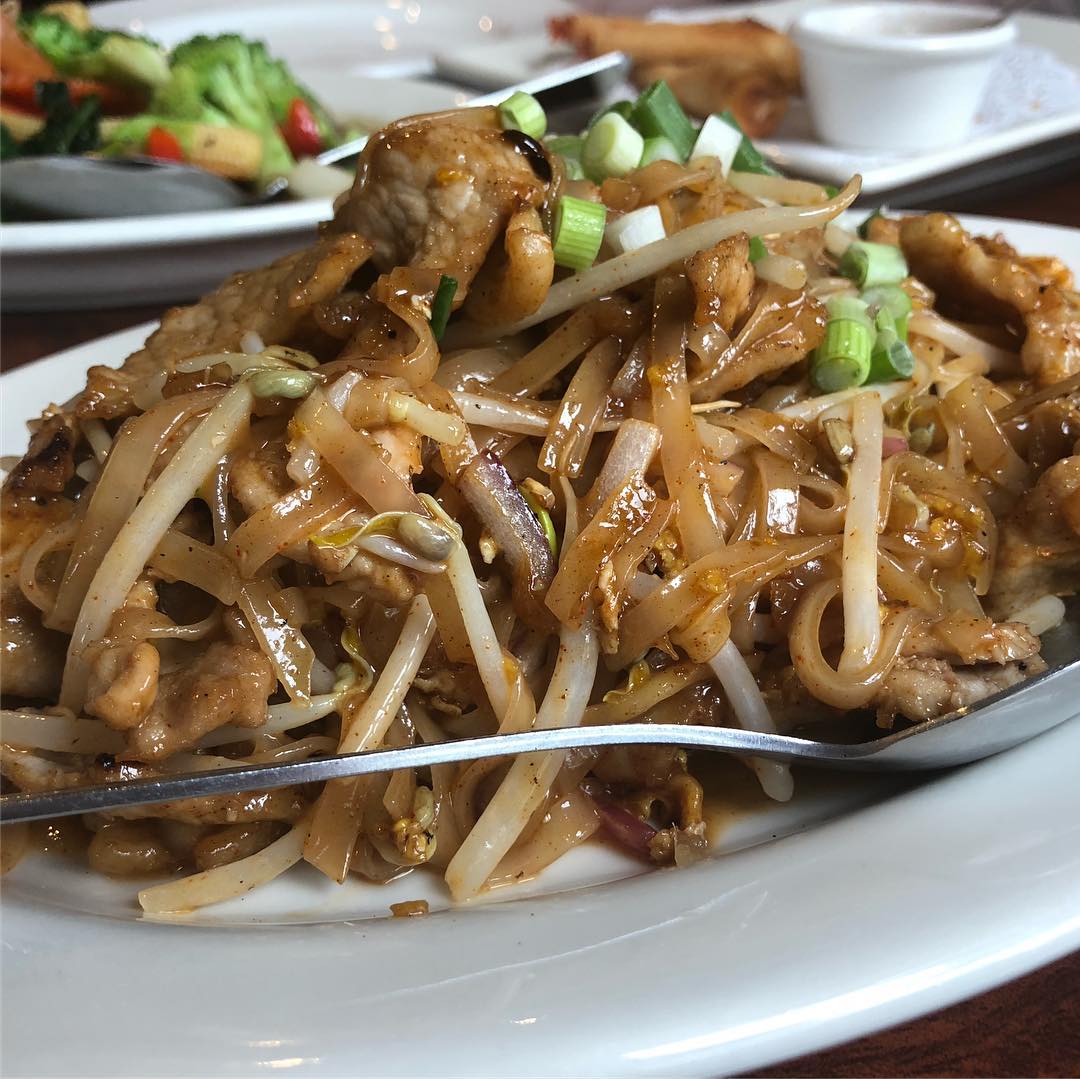 Pad Thai, chicken curry, shrimp rolls, and vegetables at Thai BBQ