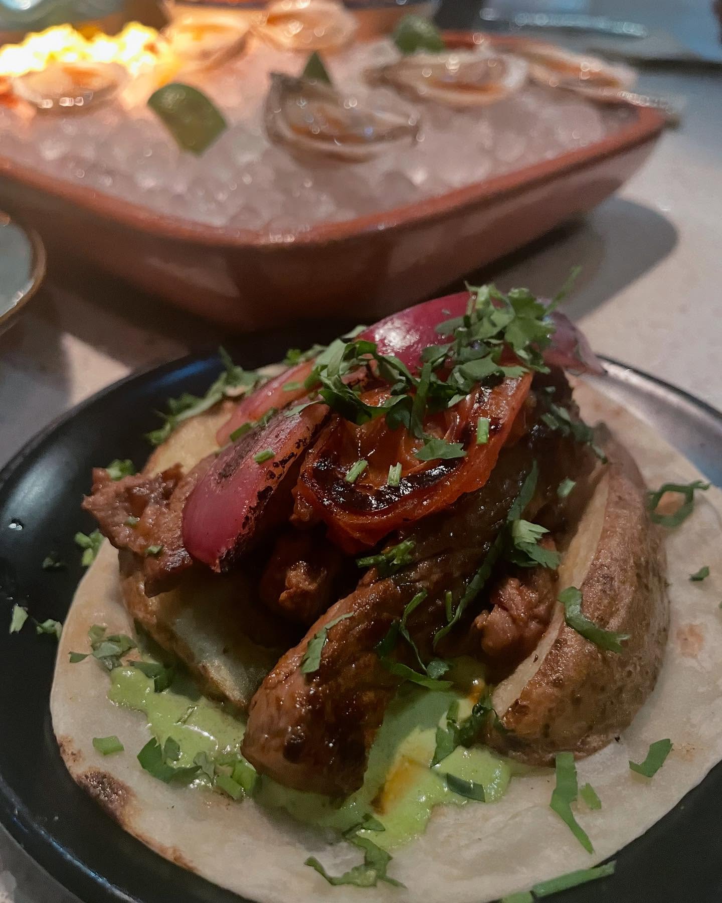 Guerrilla Tacos with carne asada taco and potato and cheese taquito